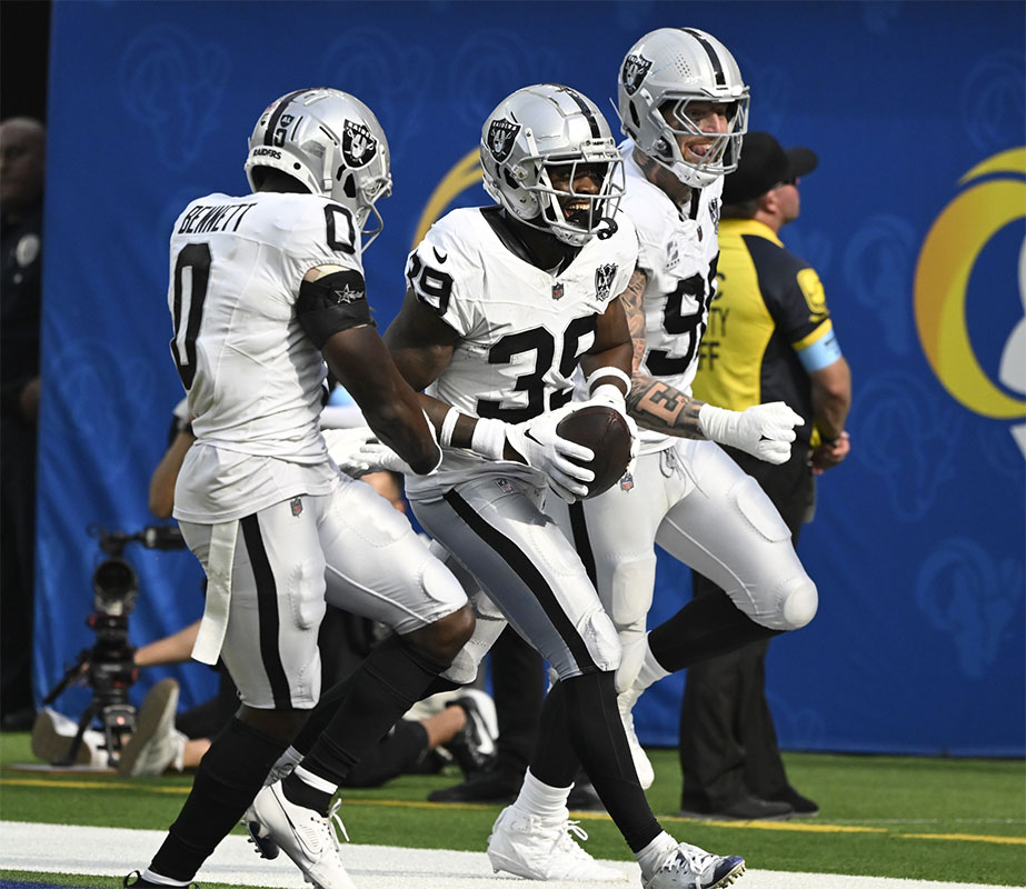 Las Vegas Raiders cornerback Nate Hobbs (39) celebrates intercepting a Los Angeles Rams quarterback Matthew Stafford (not pictured) pass during the third quarter at SoFi Stadium. Left is Las Vegas Raiders cornerback Jakorian Bennett (0), right is defensive end Maxx Crosby (98)