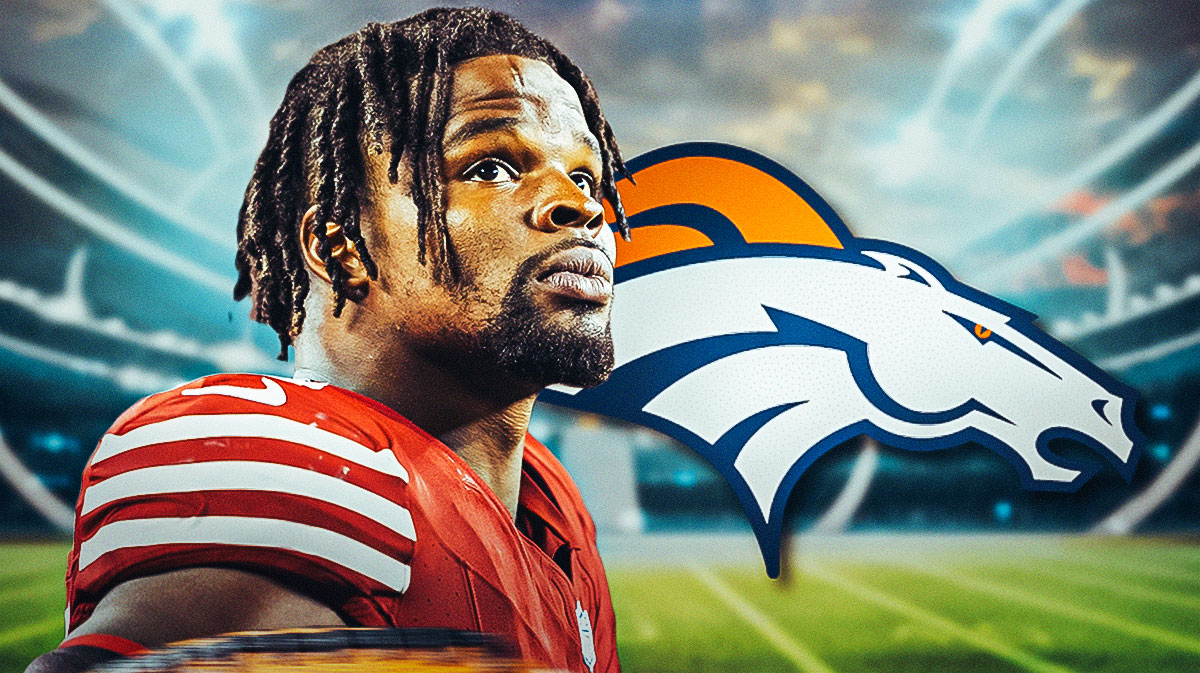 Dre Greenlaw with Broncos logo next to him