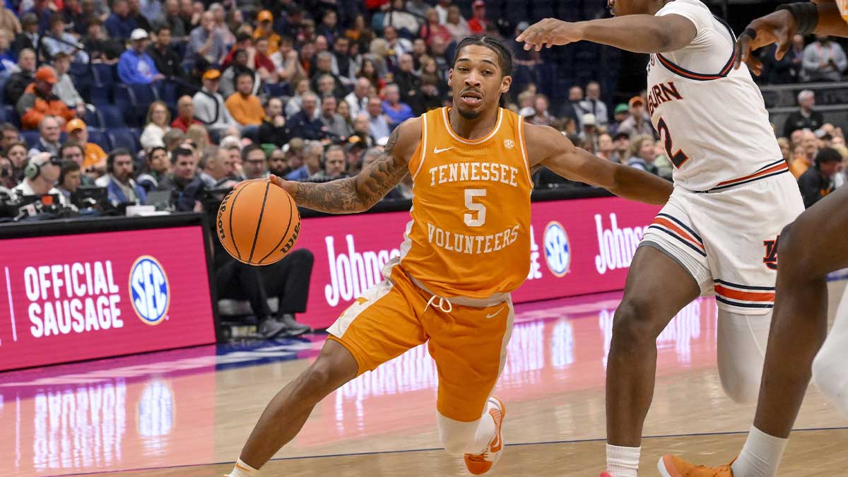 Tennessee Volunteers guard Zakai Zeigler (5) dribbles past Auburn Tigers guard Denver Jones (2) during the first half at Bridgestone Arena.