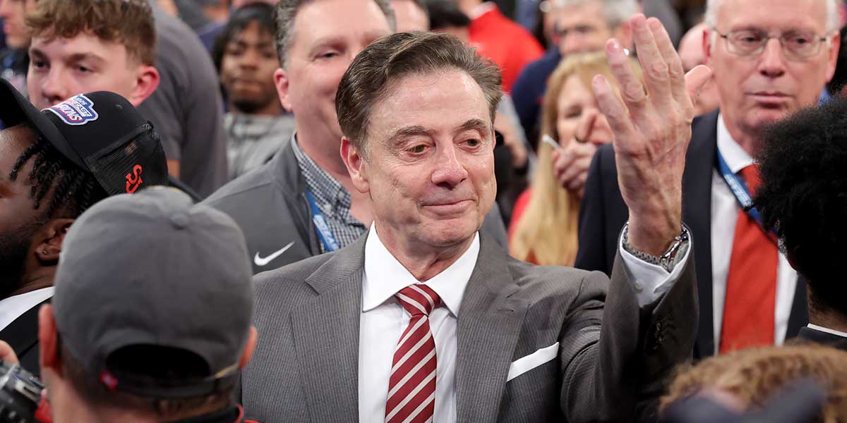 St. John's head coach Rick Pitino gestures towards campus minister for athletics Richard Rock (not pictured) to down the net after defeating the Creighton Bluejays to win the Big East Tournament at Madison Square Garden.