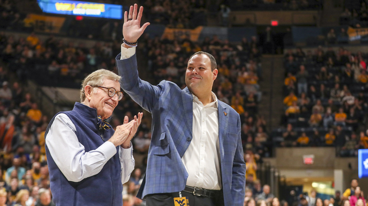 West Virginia University President Gordon Gee welcomes new West Virginia Mountaineers Athletic Director Wren Baker during the first half against the Buffalo Bulls at WVU Coliseum.