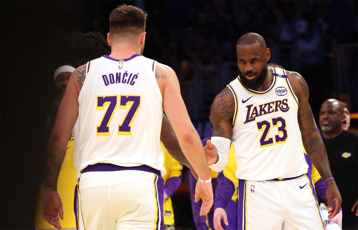Mar 2, 2025; Los Angeles, California, USA; Los Angeles Lakers forward LeBron James (23) and guard Luka Doncic (77) react after a play during the first quarter against the LA Clippers at Crypto.com Arena.