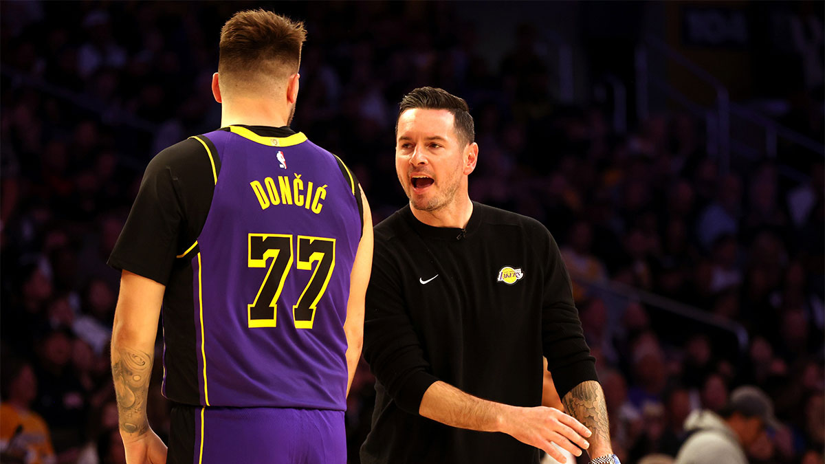 Los Angeles Lakers head coach JJ Redick talks to guard Luka Doncic (77) during the second quarter against the LA Clippers at Crypto.com Arena.