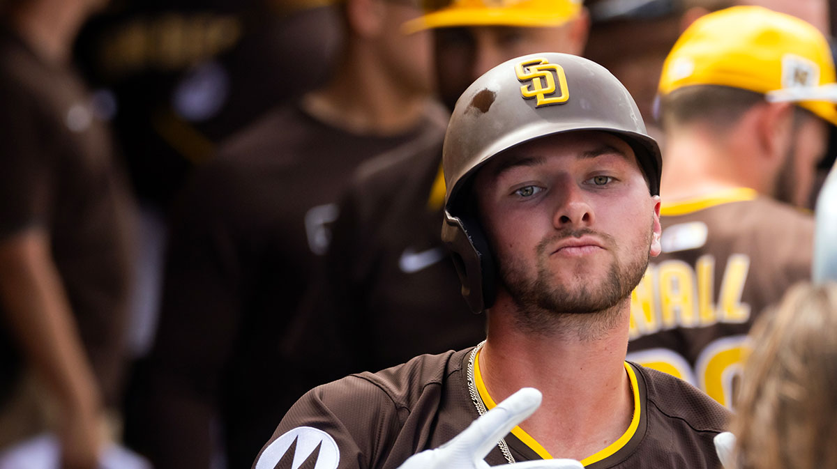 San Diego Padres outfielder Jackson Merrill celebrates with teammates in the dugout after hitting a home run against the Chicago White Sox during a spring training game at Peoria Sports Complex.