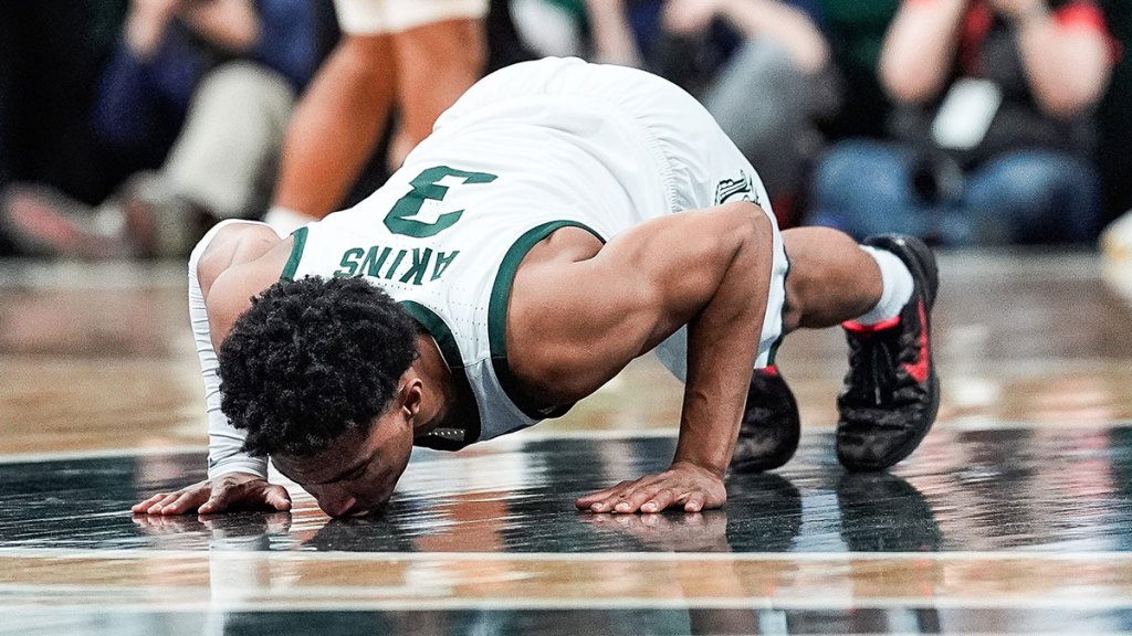 Michigan State guard Jaden Akins (3) kisses the Spartan logo during the second half against Michigan at Breslin Center in East Lansing on Sunday, March 9, 2025.