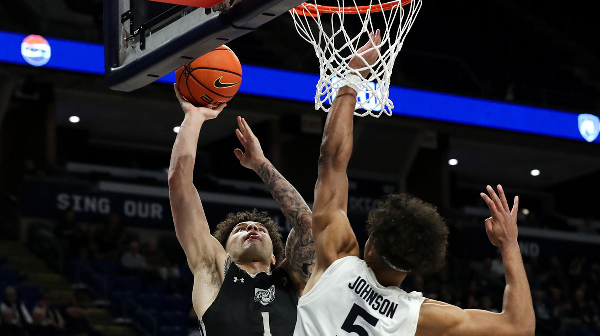 Nov 20, 2024; University Park, Pennsylvania, USA; Purdue Fort Wayne Mastodons guard Jalen Jackson (1) shoots the ball as Penn State Nittany Lions guard/forward Puff Johnson (5) defends during the second half at Bryce Jordan Center. Penn State defeated Purdue Fort Wayne 102-89.