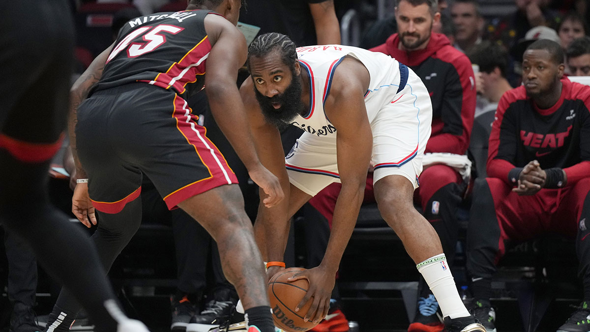 LA Clippers guard James Harden (1) looks to pass against Miami Heat guard Davion Mitchell (45) defends during the first half at Kaseya Center.