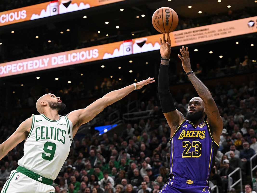 Los Angeles LeBron James (23) is trying to shoot next to the Boston Celtics Guard Derrick White (9) during the first quarter in the TD garden.