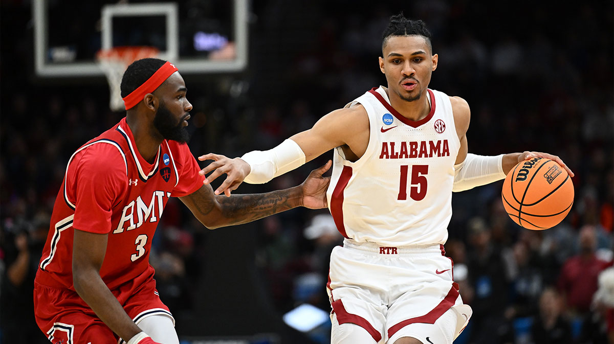 Alabama Crimson Tide forward Jarin Stevenson (15) dribbles the ball defended by Robert Morris Colonials guard Amarion Dickerson (3) in the first half during the NCAA Tournament First Round at Rocket Arena.