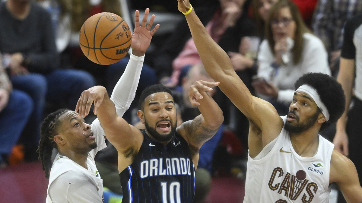 Orlando Magic guard Cory Joseph (10) throws a pass between Cleveland Cavaliers guard Darius Garland (10) and center Jarrett Allen (31) in the third quarter at Rocket Arena.