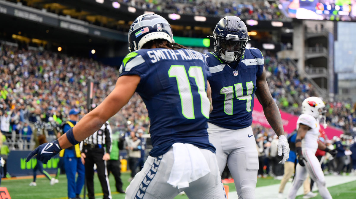 Seattle Seahawks wide receiver Jaxon Smith-Njigba (11) and wide receiver DK Metcalf (14) celebrate after Jaxon Smith-Njigba scored a touchdown against the Arizona Cardinals during the first half at Lumen Field. 