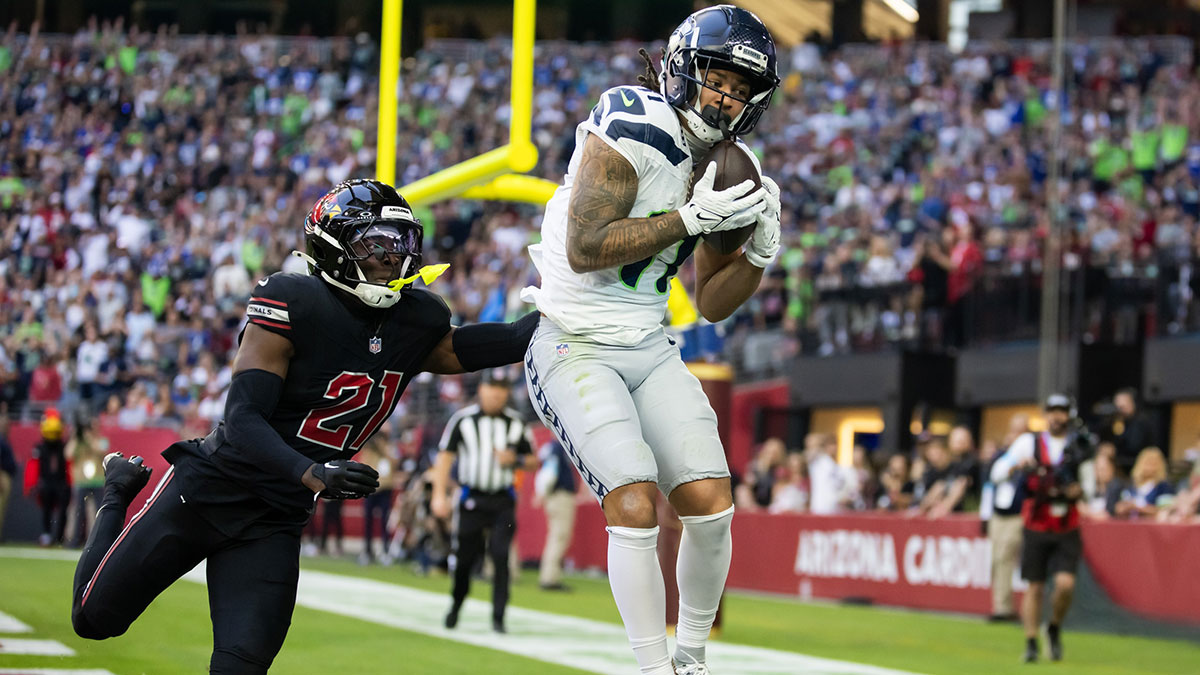 Seattle Seahawks wide receiver Jaxon Smith-Njigba (11) catches a touchdown pass against Arizona Cardinals cornerback Garrett Williams (21) in the first half at State Farm Stadium.