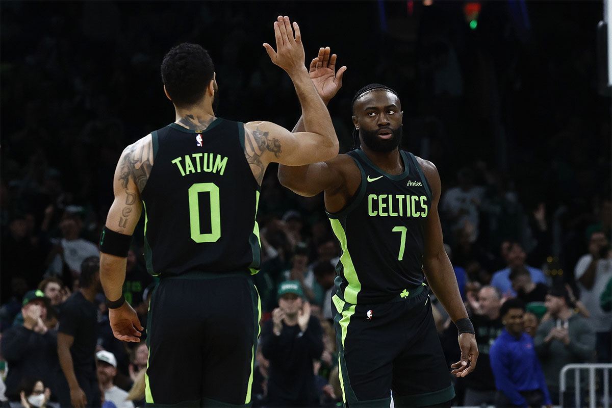 Boston Celtics guard Jaylen Brown (7) high fives forward Jayson Tatum (0) after the Cleveland Cavaliers called a timeout during the first quarter at TD Garden.