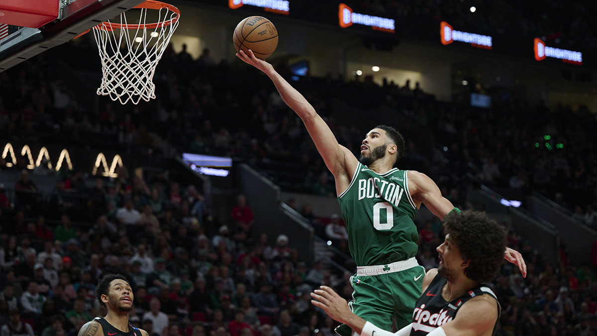 Boston Celtics forward Jayson Tatum (0) scores a basket during the second half against Portland Trail Blazers guard Matisse Thybulle (4) at Moda Center.