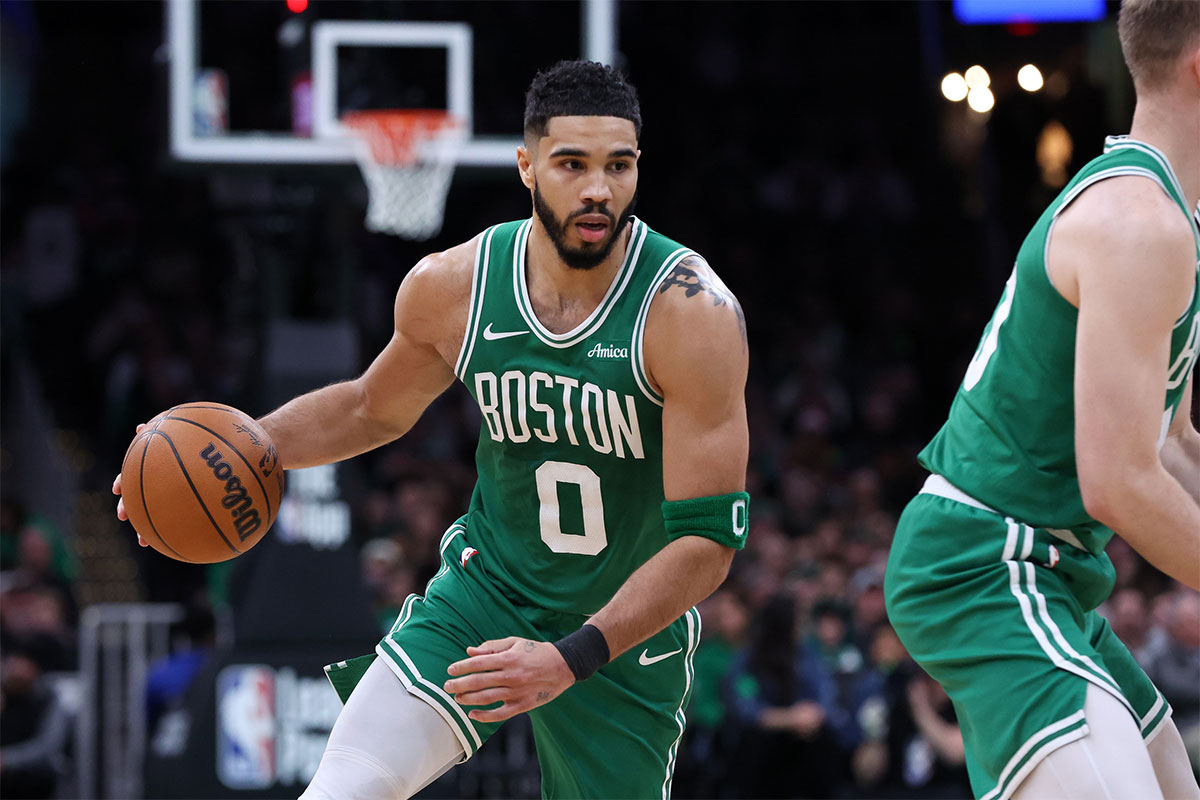 Boston Celtics forward Jayson Tatum (0) dribbles down the court during the second half against the Denver Nuggets at TD Garden.