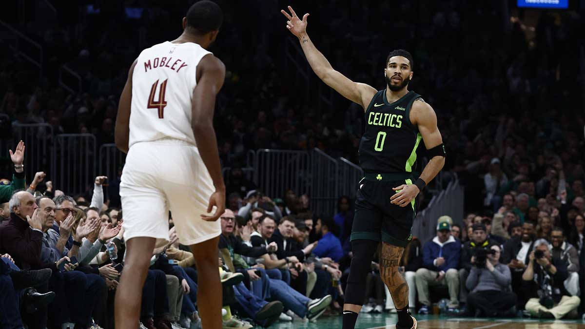 Boston Celtics forward Jayson Tatum (0) celebrates after making a three point basket as Cleveland Cavaliers forward Evan Mobley (4) looks away during the first quarter at TD Garden. 