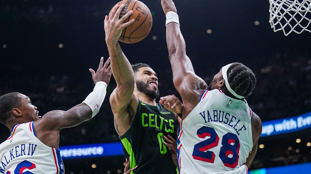 Boston Celtics Forward Jaison Tatum (0) Shoots the ball against Philadelphia 76ers forward Guerschon Yabusele (28) and keep Lonnie Walker IV (16) in the second half in TD Garden.