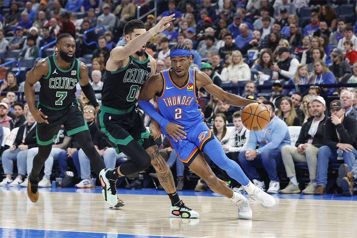 Oklahoma City Thunder guard Shai Gilgeous-Alexander (2) drives to the basket against Boston Celtics forward Jayson Tatum (0) during the second quarter at Paycom Center.