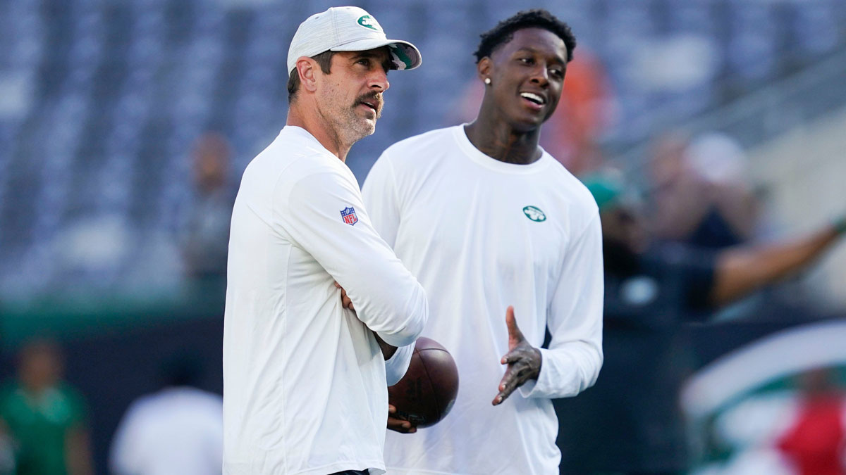 New York Jets quarterback Aaron Rodgers, left, and cornerback Sauce Gardner on the field before the Jets take on the Tampa Bay Buccaneers in a preseason NFL game at MetLife Stadium