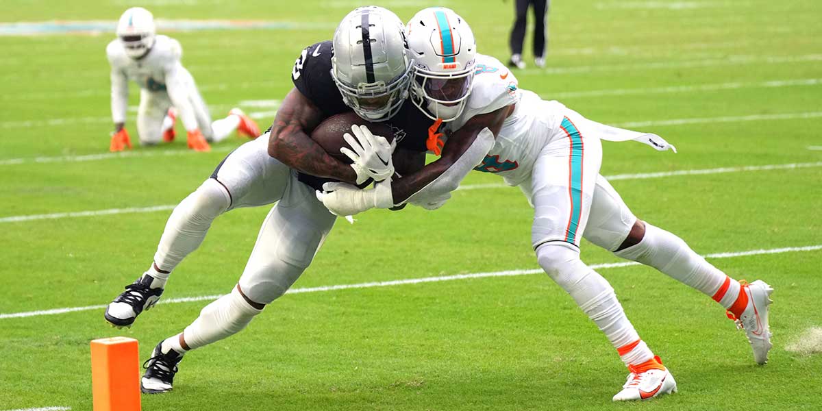 Las Vegas Raiders running back Ameer Abdullah (8) collides with Miami Dolphins safety Jevon Holland (8) as he makes his way in for a touchdown in the fourth quarter at Hard Rock Stadium. Mandatory Credit: Jim Rassol-Imagn Images