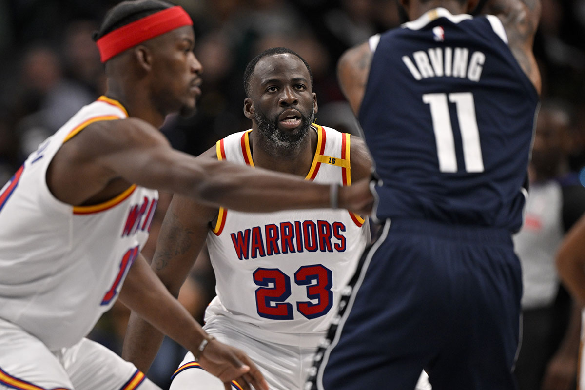 Golden State Warriors forward Draymond Green (23) and forward Jimmy Butler (10) defend against Dallas Mavericks guard Kyrie Irving (11) during the second quarter at the American Airlines Center.