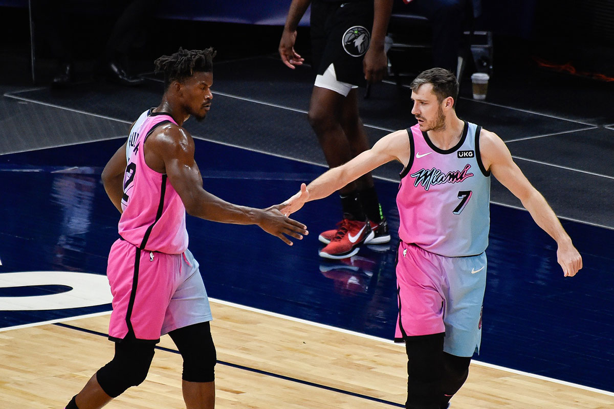Miami Heat forward Jimmy Butler (22) and guard Goran Dragic (7) react after a three point basket by Dragic against the Minnesota Timberwolves during the third quarter at Target Center.
