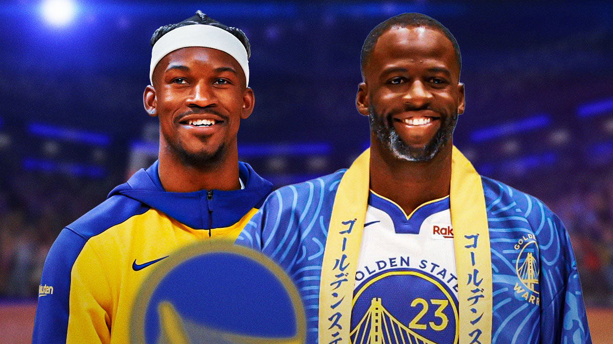 Warriors forward Jimmy Butler smiling at Draymond Green, who is also smiling.