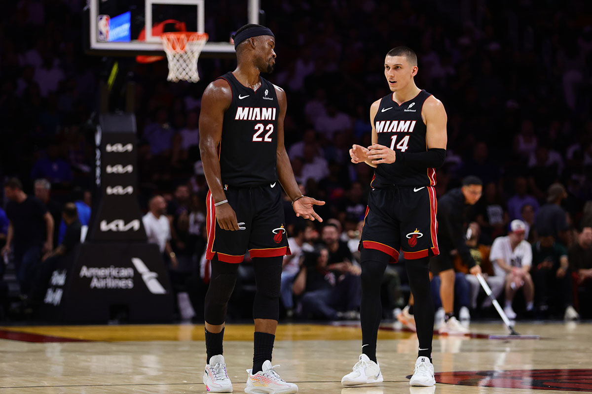 Miami Heat forward Jimmy Butler (22) and guard Tyler Herro (14) talk on the court against the New York Knicks during the second quarter at Kaseya Center.