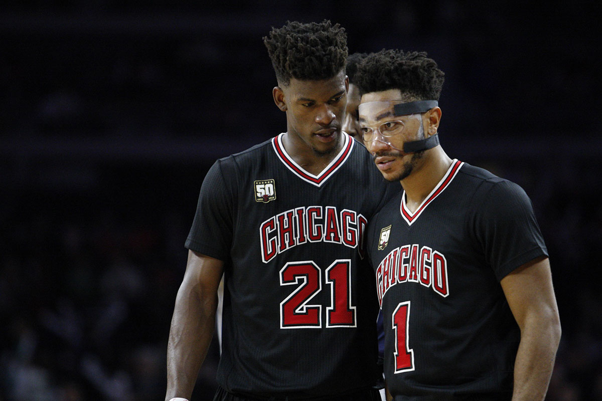 Chicago Bulls guard Jimmy Butler (21) talks to guard Derrick Rose (1) during overtime against the Detroit Pistons at The Palace of Auburn Hills. The Pistons won 98-94.