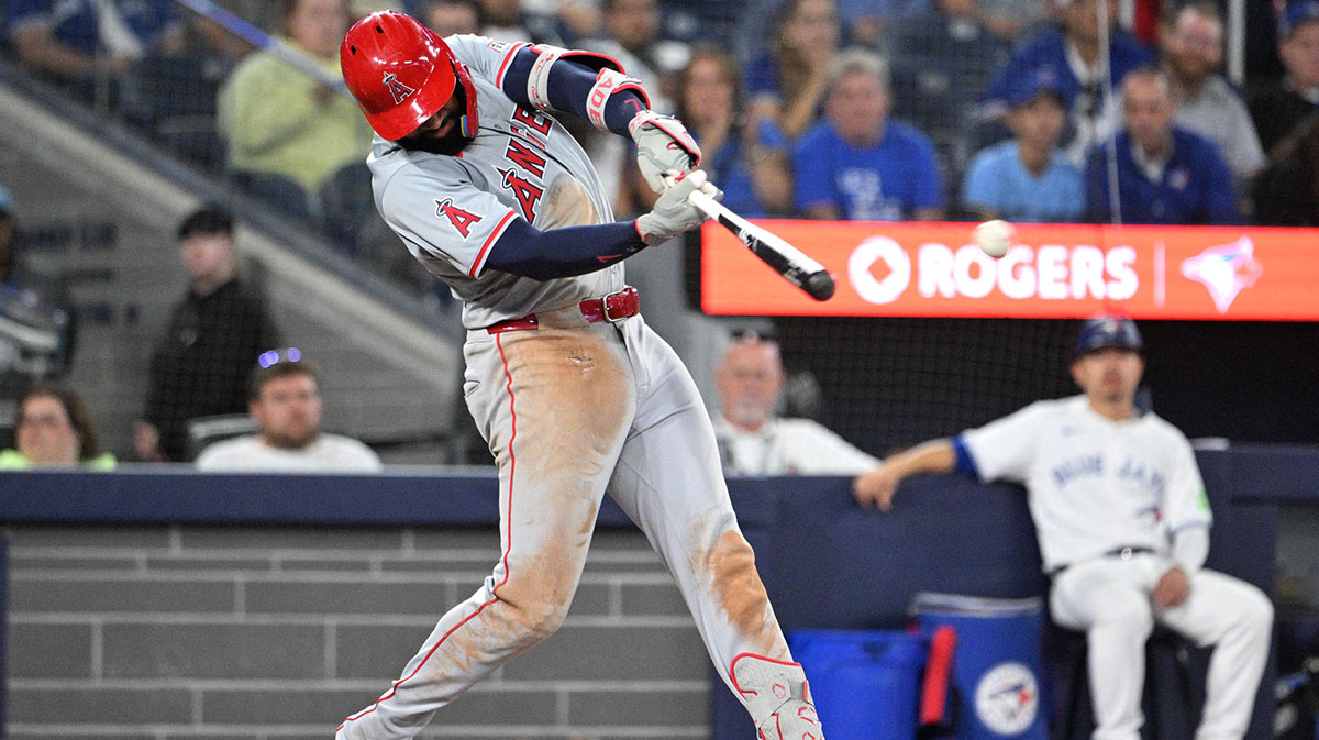 Aug 22, 2024; Toronto, Ontario, CAN; Los Angeles Angels right fielder Jo Adell (7) hits a double against the Toronto Blue Jays in the ninth inning at Rogers Centre.