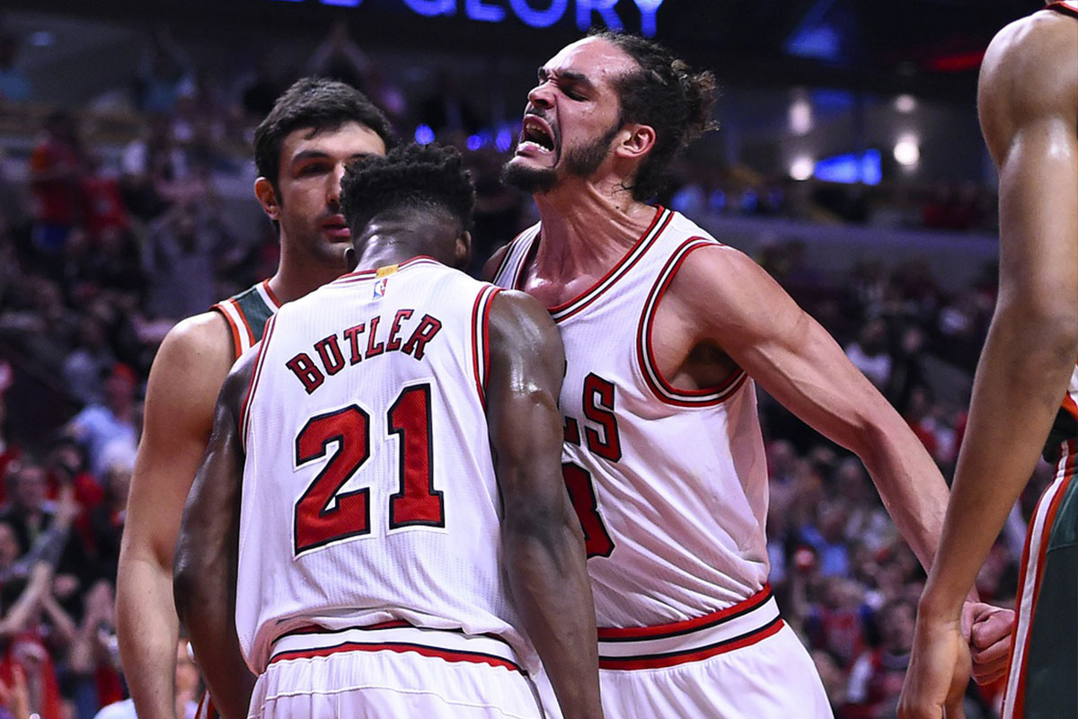 Chicago Bulls guard Jimmy Butler (21) reacts with center Joakim Noah (13) after dunking the ball against Milwaukee Bucks center Zaza Pachulia (not pictured) during the second half in game two of the first round of the 2015 NBA Playoffs at the United Center. The Chicago Bulls defeat the Milwaukee Bucks 92-81.