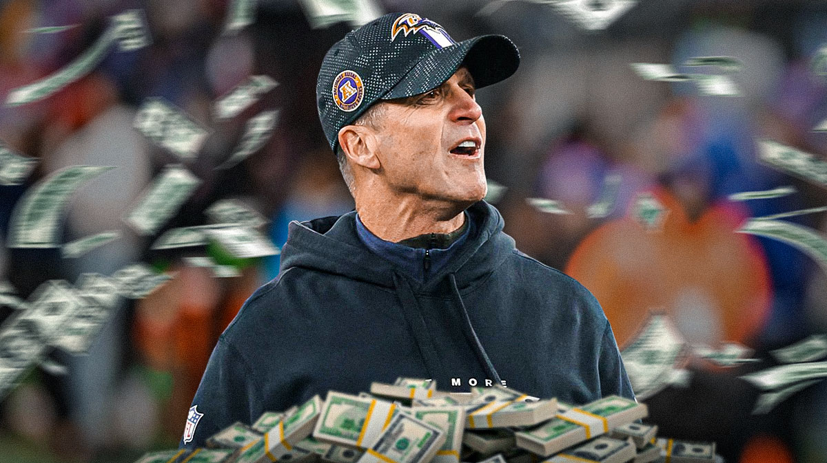 IMAGE: Ravens John Harbaugh with money around him.