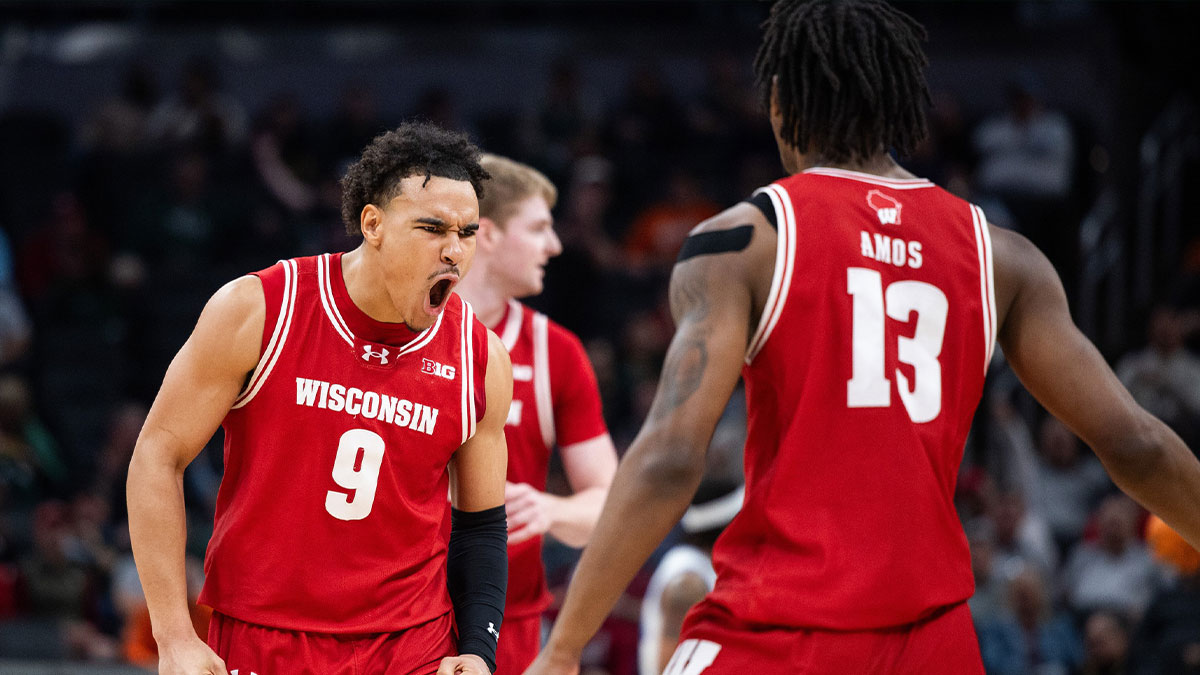 Wisconsin Badgers guard John Tonje (9) celebrates a made basket in the first half against the UCLA Bruins at Gainbridge Fieldhouse.