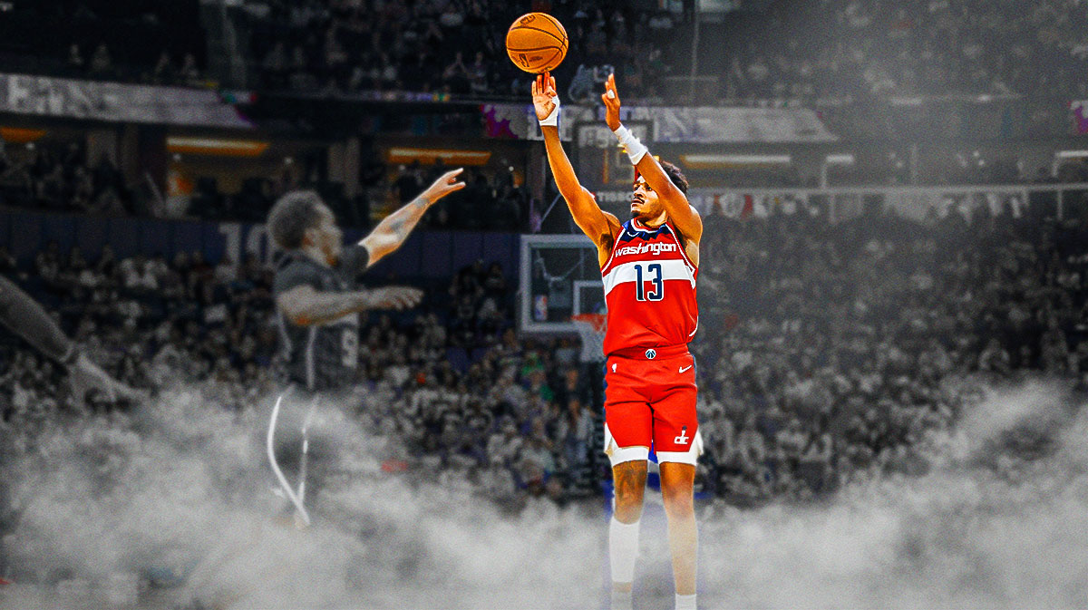 Jordan Poole shoots basketball from three-point line