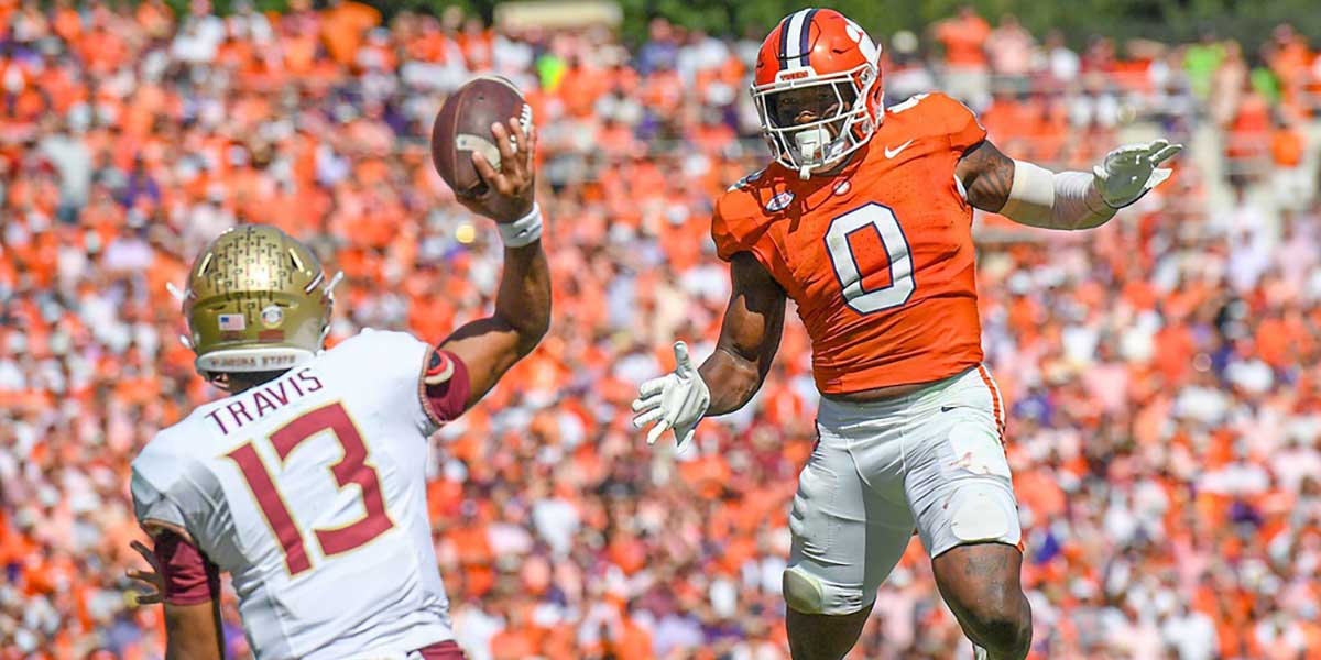 Clemson linebacker Barrett Carter (0) pressures Florida State University quarterback Jordan Travis (13) during the fourth quarter Sep 23, 2023; Clemson, South Carolina, USA; at Memorial Stadium.