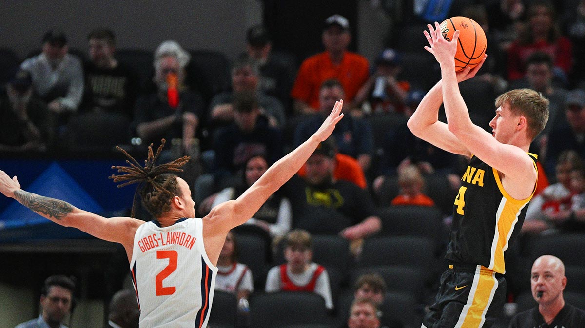 Iowa Hawkeyes guard Josh Dix (4) shoots over Illinois Fighting Illini guard Dra Gibbs-Lawhorn (2) during the first half at Gainbridge Fieldhouse.
