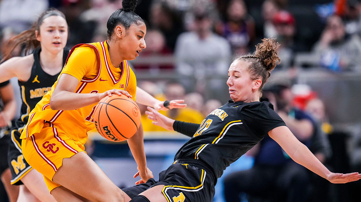 Michigan Wolverines guard Jordan Hobbs (10) takes a charge from USC Trojans guard JuJu Watkins (12) on Saturday, March 8, 2025, in a semifinals game at the 2025 TIAA Big Ten Women's Basketball Tournament between the Iowa Hawkeyes and the Ohio State Buckeyes at Gainbridge Fieldhouse in Indianapolis.