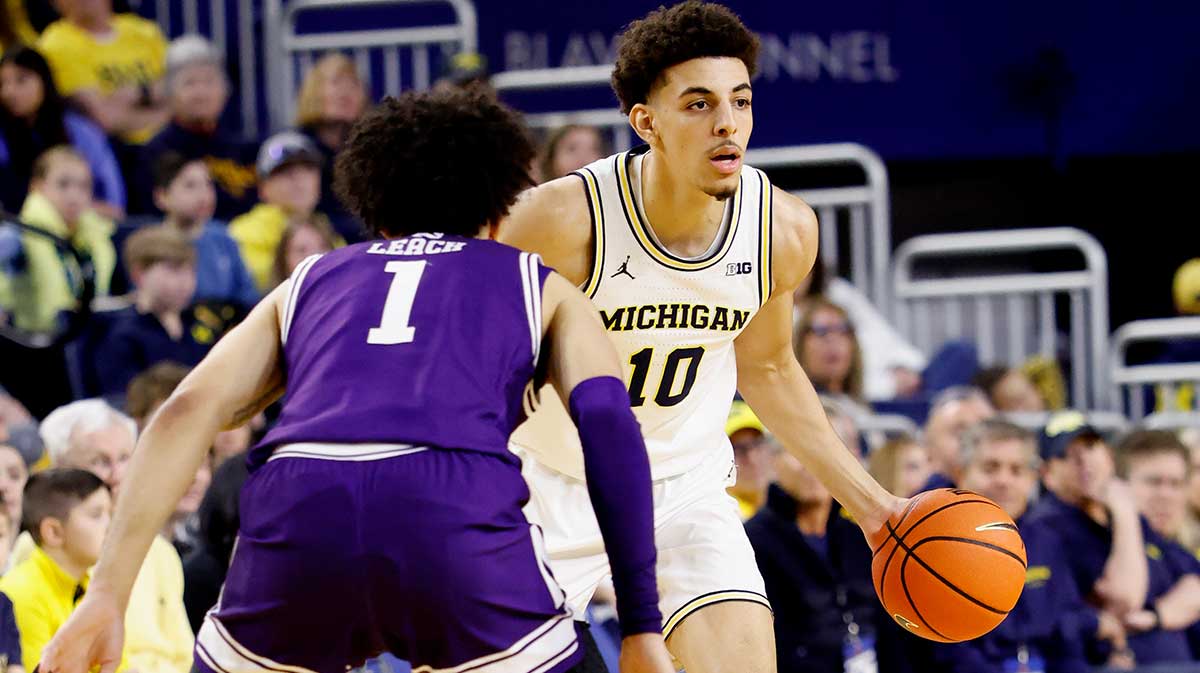 Michigan Wolverines guard Justin Pippen (10) dribbles against Northwestern Wildcats guard Jalen Leach (1) in the first half at Crisler Center.