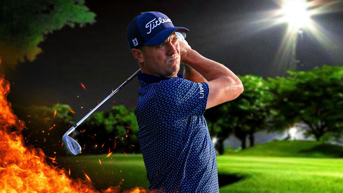 Justin Thomas with his golf club on fire golf course background