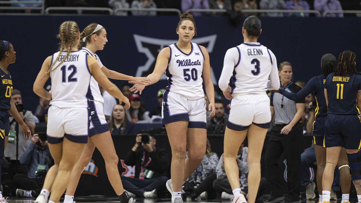 Teammates high five Kansas State Wildcats center Ayoka Lee (50) after making a basket against the West Virginia Mountaineers during the first half at T-Mobile Center.