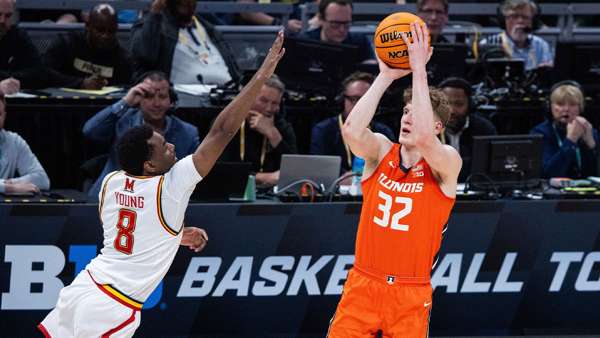 The Illinois fighting goalkeeper Illini Kasparas Jakucionis (32) pulls the ball while the terraaps of Maryland Jay Young (8) defends first half at Gainbridge Fieldhouse.