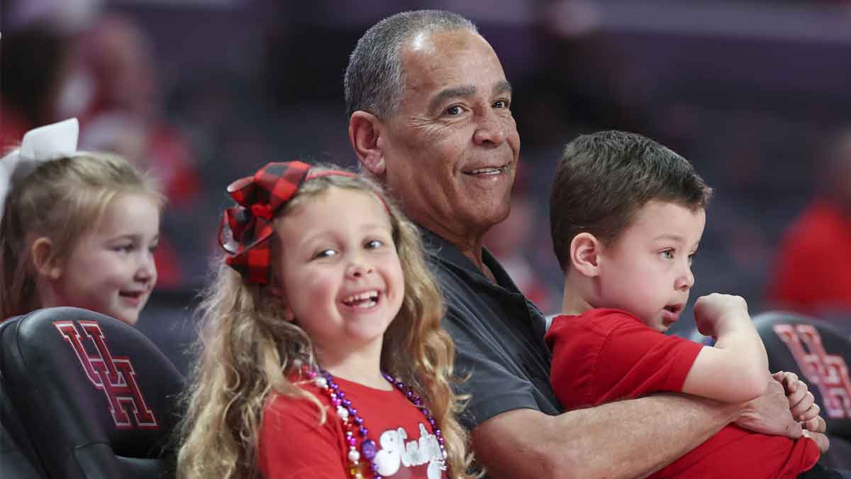 Houston Cougars head coach Kelvin Sampson sits with children before the game against the Kansas Jayhawks at Fertitta Center.