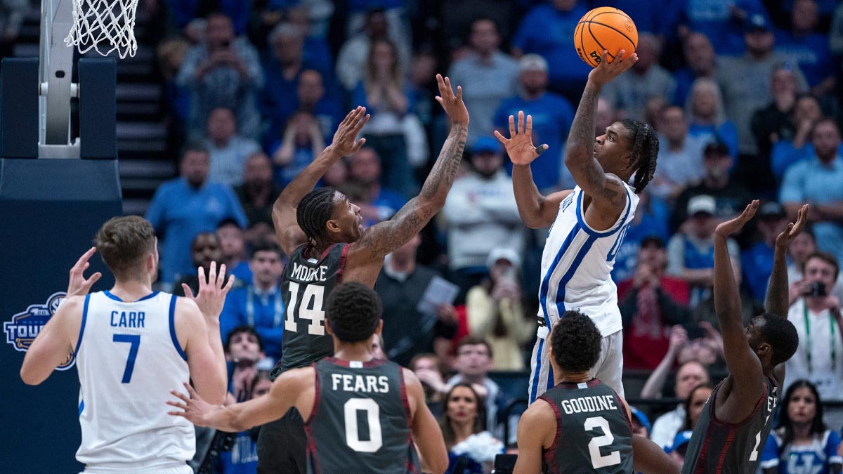 Kentucky Wildcats guard Otega Oweh (00) puts up the game-winning shot over Oklahoma Sooners forward Jalon Moore (14) as the clock wound down during their second round game of the SEC Men's Basketball Tournament