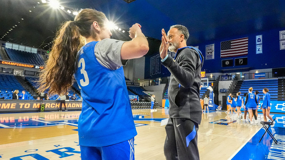 Kentucky coach Kenny Brooks high-fives players during shooting drills during practice ahead of the Wildcats’ NCAA first-round game against Liberty