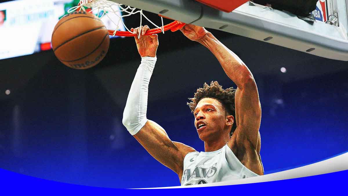 Mavericks Kessler Edwards dunking a basketball.