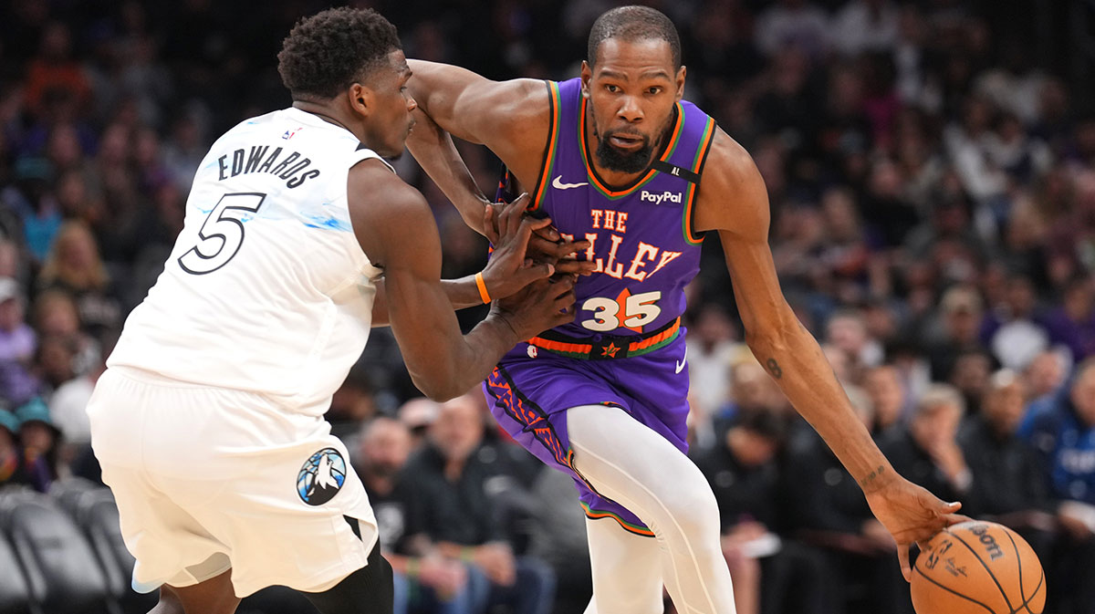 Phoenix Suns forward Kevin Durant (35) dribbles against Minnesota Timberwolves guard Anthony Edwards (5) during the second half at Footprint Center.