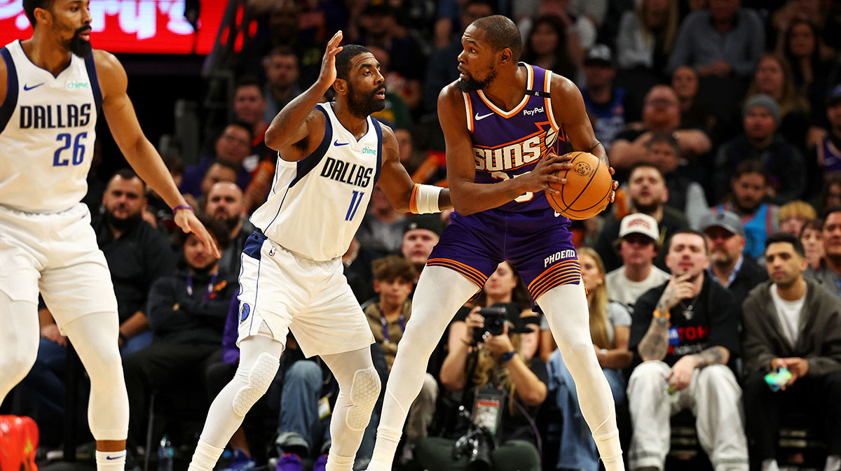  Phoenix Suns forward Kevin Durant (35) handles the ball against Dallas Mavericks guard Kyrie Irving (11) during the third quarter at Footprint Center.