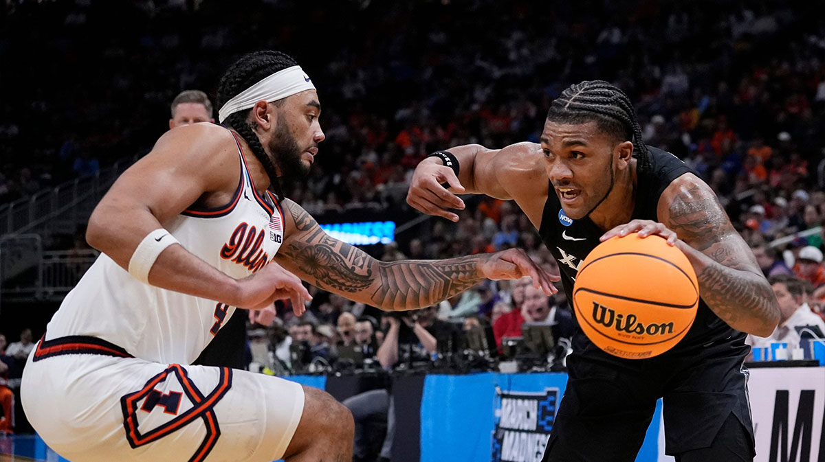 Xavier guard Dayvion McKnight (20) drives up the court as he is guarded by Illinois guard Kylan Boswell (4) during the second half of their first round NCAA men’ s basketball tournament game on Friday March 21, 2025 at Fiserv Forum in Milwaukee, Wis.