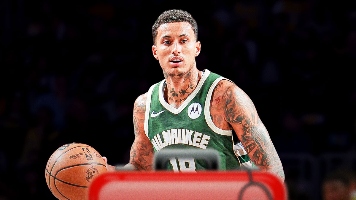 Image of Bucks forward Kyle Kuzma with medical cross emoji next to him.
