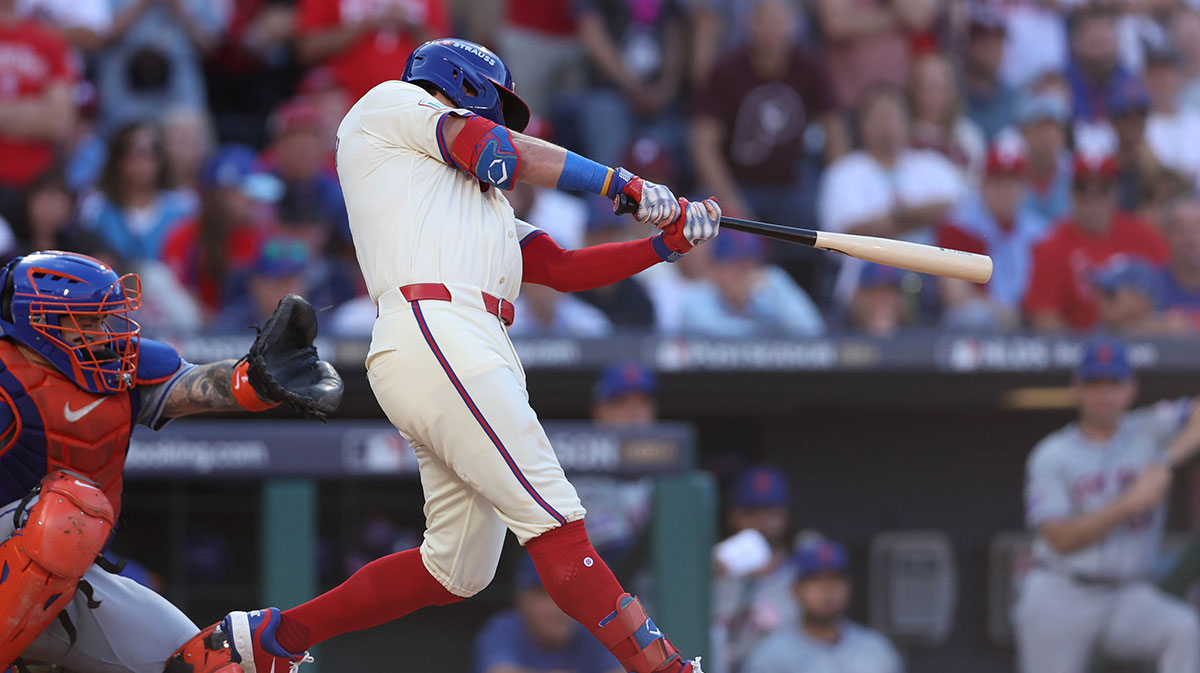 Oct 5, 2024; Philadelphia, PA, USA; Philadelphia Phillies designated hitter Kyle Schwarber (12) hits a solo home run against the New York Mets in the first inning in game one of the NLDS for the 2024 MLB Playoffs at Citizens Bank Park. 